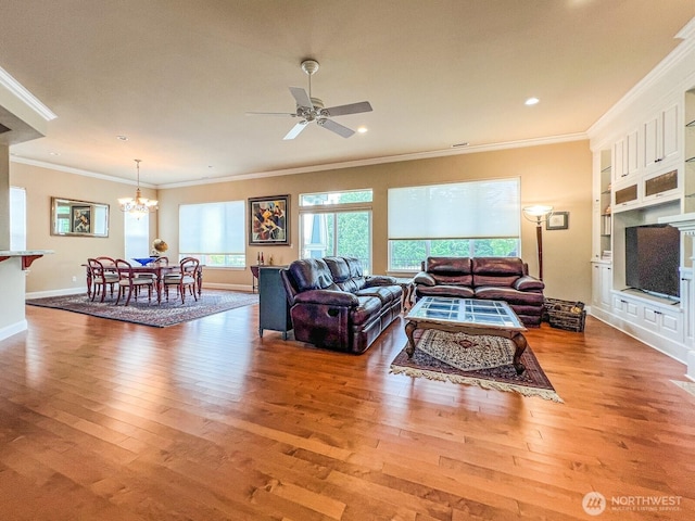 8621 Bainbridge Loop NE, Lacey, WA 98516 - living room featuring a chandelier, crown molding, wood finished floors, ceiling fan, and recessed lighting