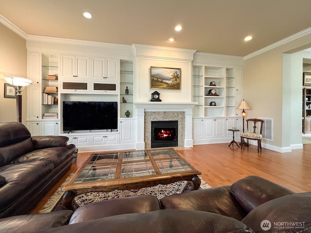 8621 Bainbridge Loop NE, Lacey, WA 98516 - living area featuring crown molding, wood finished floors, a fireplace with flush hearth, recessed lighting, and built in shelves