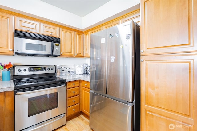 3201 Pacific Ave Unit 403, Tacoma, WA 98418 - kitchen featuring appliances with stainless steel finishes and light wood-style floors
