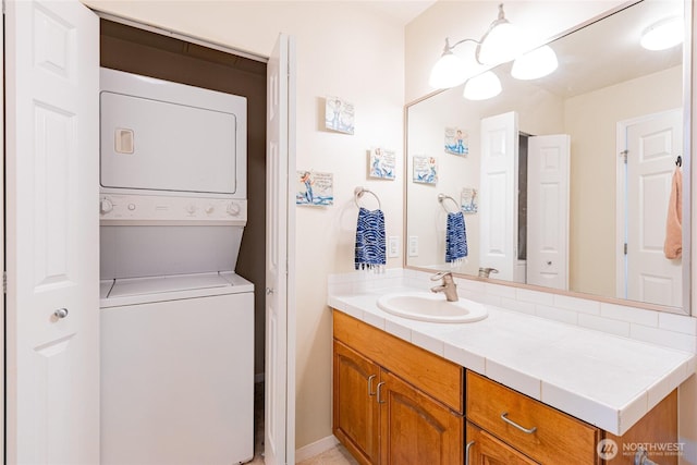 3201 Pacific Ave Unit 403, Tacoma, WA 98418 - bathroom featuring stacked washer and clothes dryer and vanity