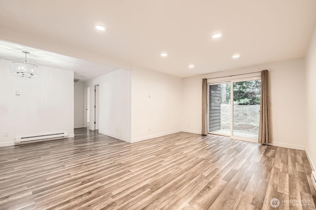 14760 NE 31st St Unit A105, Bellevue, WA 98007 - unfurnished room featuring a baseboard radiator, light wood-style floors, a chandelier, and recessed lighting