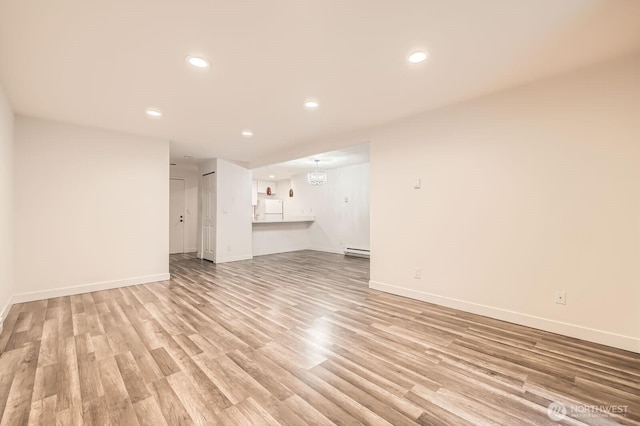 14760 NE 31st St Unit A105, Bellevue, WA 98007 - unfurnished living room with light wood-style floors, recessed lighting, and baseboard heating