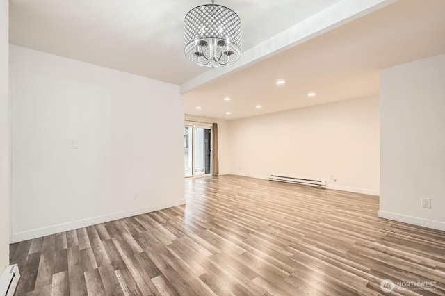 14760 NE 31st St Unit A105, Bellevue, WA 98007 - empty room featuring baseboard heating, recessed lighting, wood finished floors, a chandelier, and a baseboard radiator