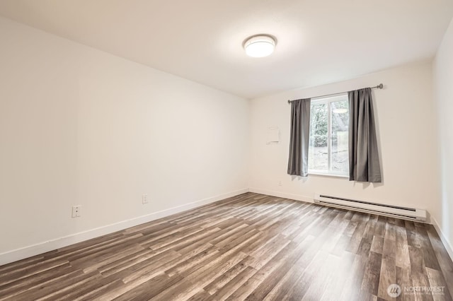 14760 NE 31st St Unit A105, Bellevue, WA 98007 - spare room featuring a baseboard heating unit and dark wood-style floors