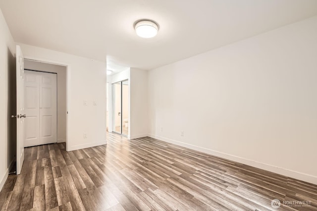 14760 NE 31st St Unit A105, Bellevue, WA 98007 - spare room featuring dark wood-type flooring and baseboards