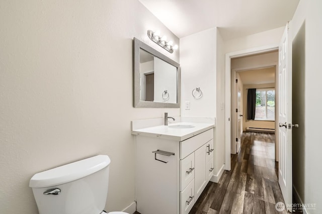 14760 NE 31st St Unit A105, Bellevue, WA 98007 - half bath featuring vanity, wood finished floors, and a baseboard heating unit
