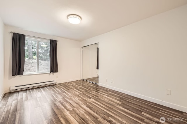 14760 NE 31st St Unit A105, Bellevue, WA 98007 - empty room featuring a baseboard radiator and wood finished floors