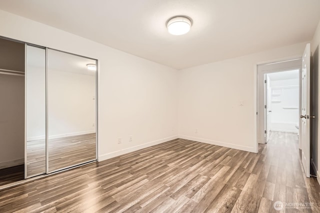 14760 NE 31st St Unit A105, Bellevue, WA 98007 - unfurnished bedroom featuring wood finished floors and a closet