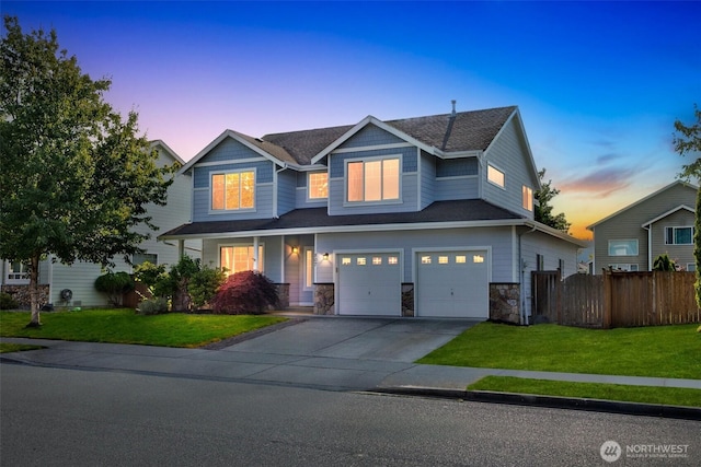 807 Williams St NW, Orting, WA 98360 - craftsman house with driveway, a garage, stone siding, and a porch