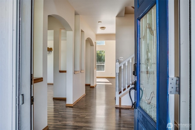 807 Williams St NW, Orting, WA 98360 - foyer entrance with arched walkways, dark wood-style flooring, and stairs