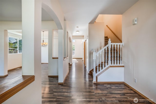 807 Williams St NW, Orting, WA 98360 - entryway featuring wood finished floors, stairs, a chandelier, and arched walkways