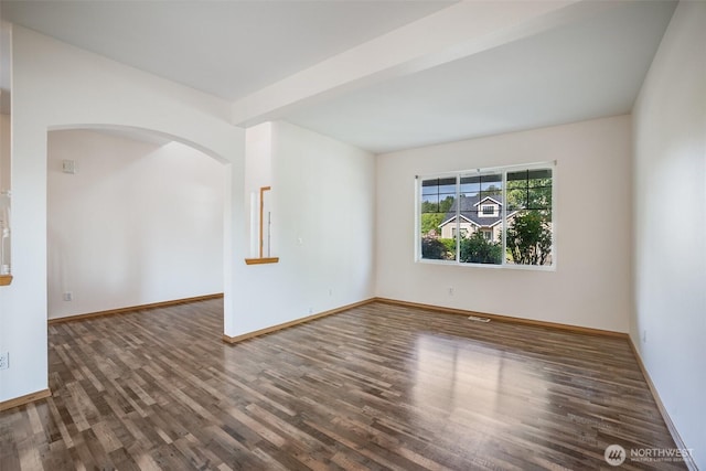807 Williams St NW, Orting, WA 98360 - empty room featuring wood finished floors and arched walkways