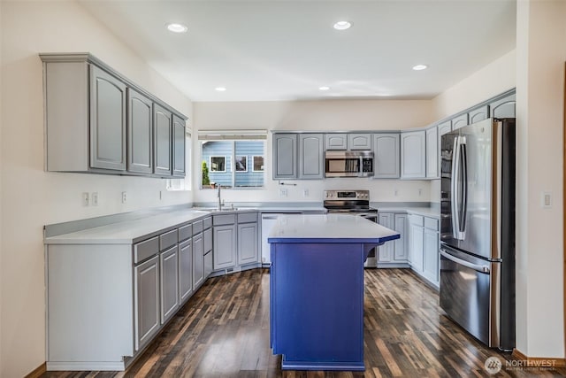 807 Williams St NW, Orting, WA 98360 - kitchen featuring stainless steel appliances, gray cabinetry, a center island, dark wood-style floors, and recessed lighting