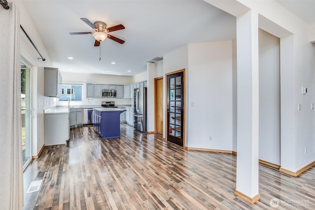 807 Williams St NW, Orting, WA 98360 - kitchen with appliances with stainless steel finishes, gray cabinetry, wood finished floors, ceiling fan, and recessed lighting