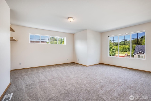 807 Williams St NW, Orting, WA 98360 - carpeted spare room with baseboards