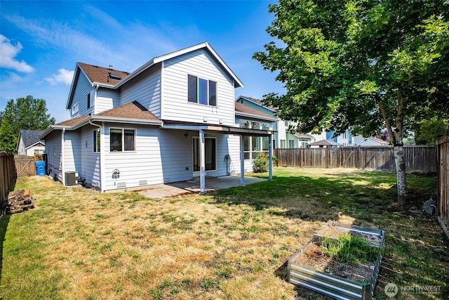 807 Williams St NW, Orting, WA 98360 - rear view of house with a patio area, a shingled roof, a fenced backyard, and a vegetable garden