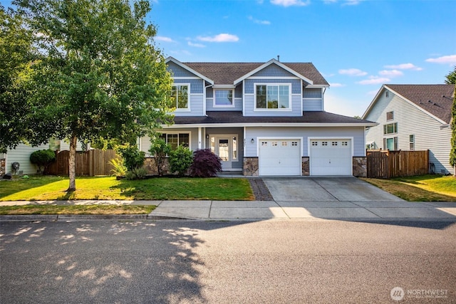 807 Williams St NW, Orting, WA 98360 - craftsman inspired home with driveway, an attached garage, stone siding, and roof with shingles