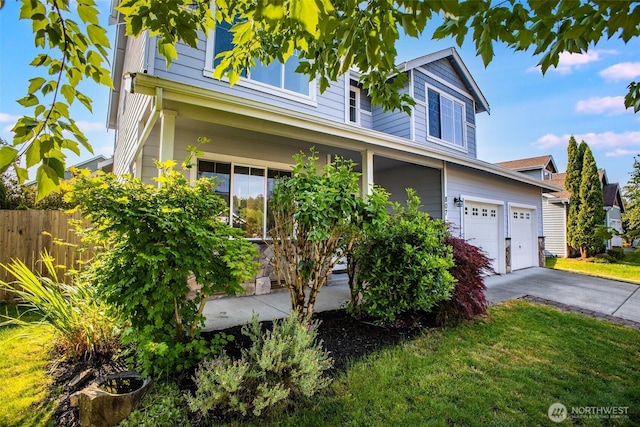 807 Williams St NW, Orting, WA 98360 - traditional-style home featuring an attached garage and concrete driveway