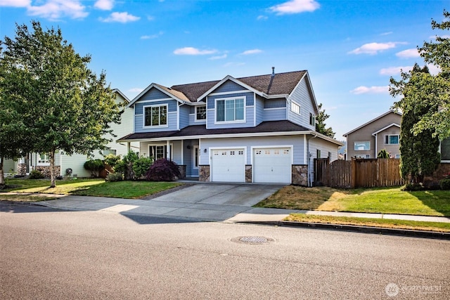 807 Williams St NW, Orting, WA 98360 - view of front of property with concrete driveway, an attached garage, and stone siding