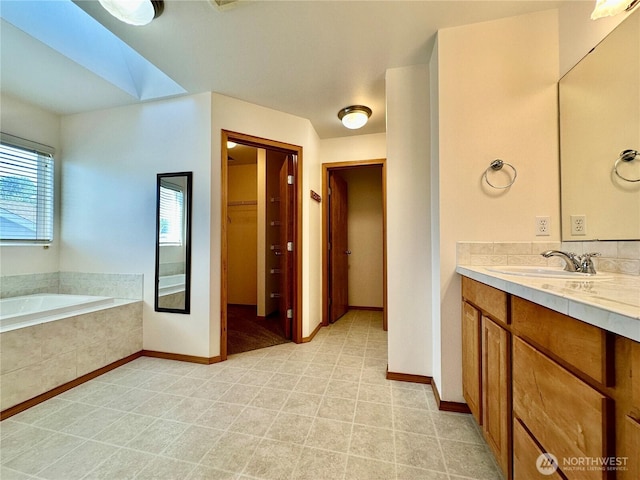 807 Williams St NW, Orting, WA 98360 - bathroom featuring vanity, a bath, and a walk in closet