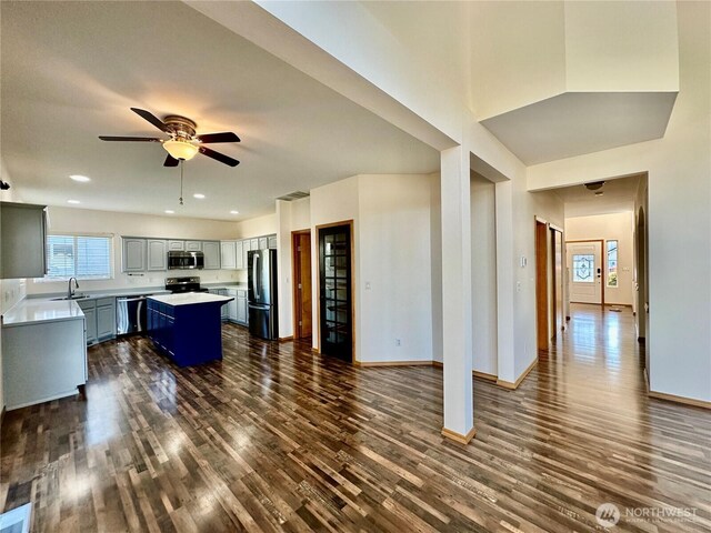 807 Williams St NW, Orting, WA 98360 - kitchen with stainless steel appliances, dark wood finished floors, a kitchen island, plenty of natural light, and recessed lighting