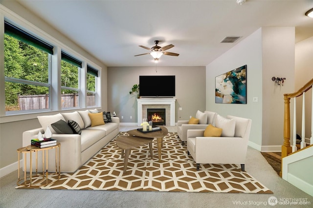 20313 194th Ave E, Orting, WA 98360 - carpeted living area featuring stairs, a fireplace, and ceiling fan