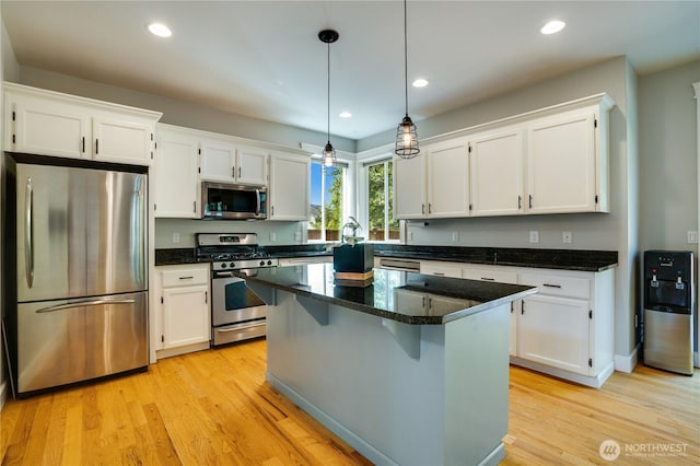 20313 194th Ave E, Orting, WA 98360 - kitchen with appliances with stainless steel finishes, white cabinets, light wood finished floors, recessed lighting, and a kitchen island