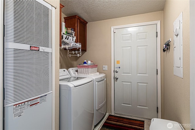 17612 19th Ave E Unit 83, Spanaway, WA 98387 - washroom with a heating unit, separate washer and dryer, cabinet space, and a textured ceiling