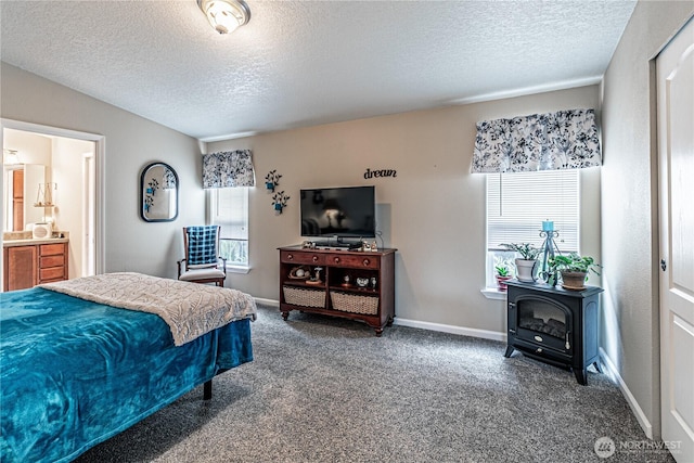 17612 19th Ave E Unit 83, Spanaway, WA 98387 - carpeted bedroom with a textured ceiling, a wood stove, and connected bathroom