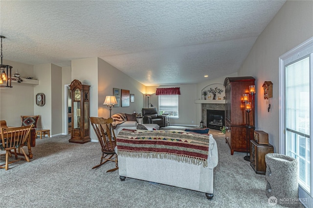 17612 19th Ave E Unit 83, Spanaway, WA 98387 - living room with carpet flooring, a textured ceiling, a glass covered fireplace, and a chandelier
