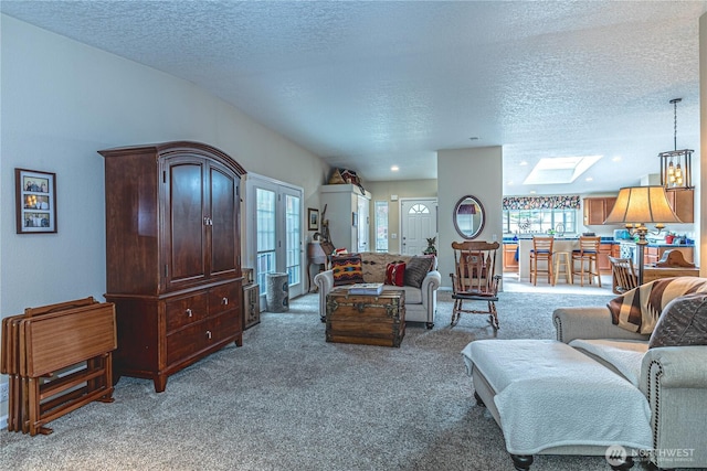17612 19th Ave E Unit 83, Spanaway, WA 98387 - living area featuring light colored carpet, a skylight, and a textured ceiling
