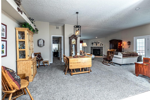 17612 19th Ave E Unit 83, Spanaway, WA 98387 - living area with a textured ceiling, carpet floors, and a tile fireplace