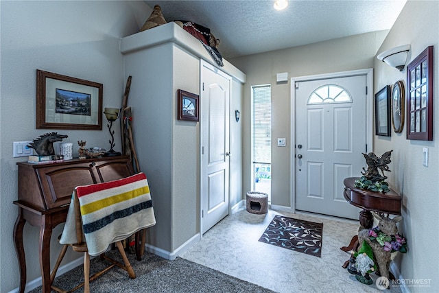 17612 19th Ave E Unit 83, Spanaway, WA 98387 - carpeted entryway featuring baseboards and a textured ceiling