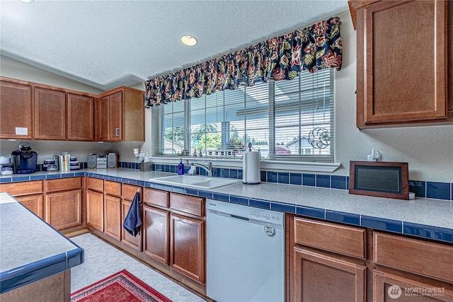 17612 19th Ave E Unit 83, Spanaway, WA 98387 - kitchen with white dishwasher, a textured ceiling, brown cabinetry, recessed lighting, and light countertops