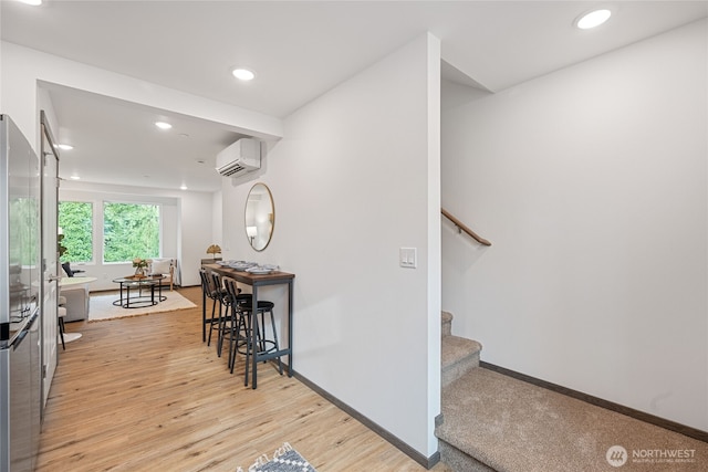 1339 Nolta Loop NE, Bainbridge Island, WA 98110 - hallway featuring a wall mounted AC, light wood-style flooring, stairs, and recessed lighting