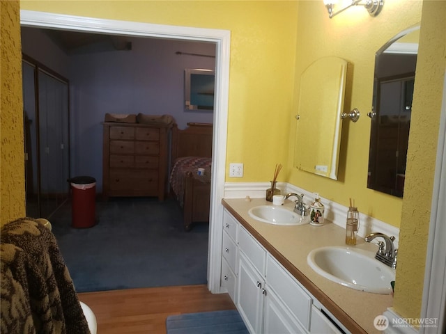 70 NE Wanda Ln, Belfair, WA 98528 - ensuite bathroom with double vanity and wood finished floors