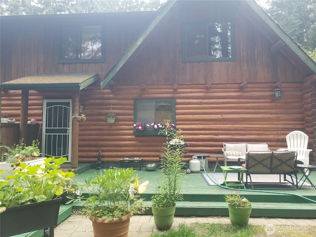 70 NE Wanda Ln, Belfair, WA 98528 - back of house featuring log exterior, an outdoor living space, and a wooden deck