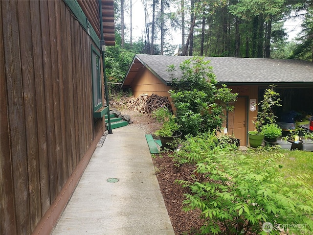 70 NE Wanda Ln, Belfair, WA 98528 - view of property exterior with entry steps and roof with shingles