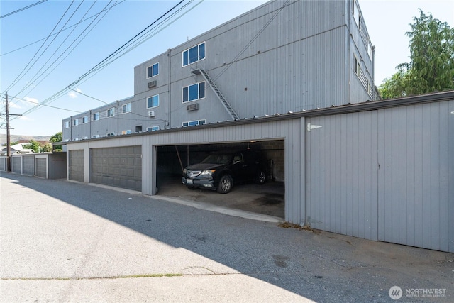 201 Pennsylvania Ave Unit 15, Wenatchee, WA 98801 - view of side of home with community garages, an outdoor structure, and a metal roof