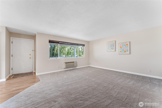 201 Pennsylvania Ave Unit 15, Wenatchee, WA 98801 - unfurnished living room featuring a wall mounted air conditioner, a textured ceiling, and carpet floors