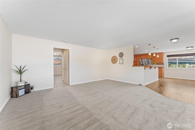 201 Pennsylvania Ave Unit 15, Wenatchee, WA 98801 - unfurnished living room with light carpet and baseboards