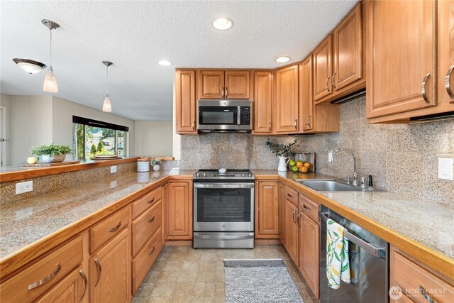 201 Pennsylvania Ave Unit 15, Wenatchee, WA 98801 - kitchen featuring appliances with stainless steel finishes, tile counters, tasteful backsplash, hanging light fixtures, and recessed lighting