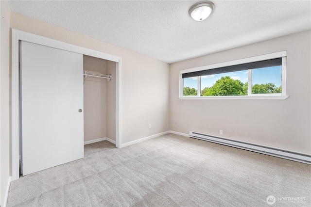 201 Pennsylvania Ave Unit 15, Wenatchee, WA 98801 - unfurnished bedroom with baseboard heating, carpet, a closet, and a textured ceiling