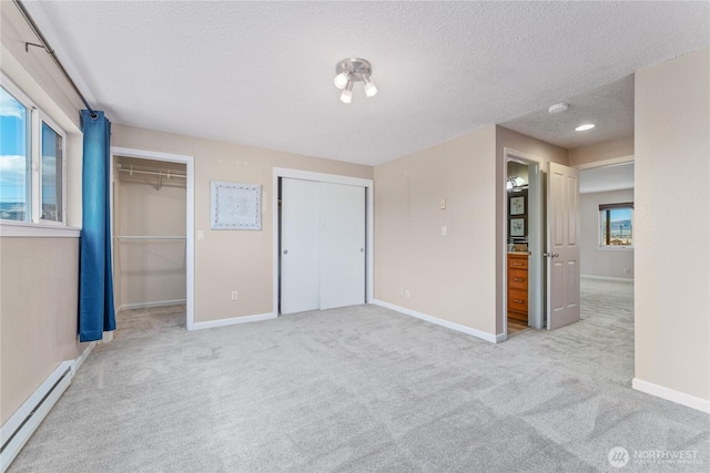 201 Pennsylvania Ave Unit 15, Wenatchee, WA 98801 - unfurnished bedroom with a baseboard heating unit, two closets, a textured ceiling, and carpet