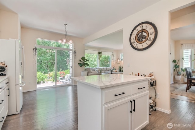 35055 41st Pl S, Auburn, WA 98001 - kitchen featuring freestanding refrigerator, dark wood-style flooring, open floor plan, white cabinetry, and healthy amount of natural light
