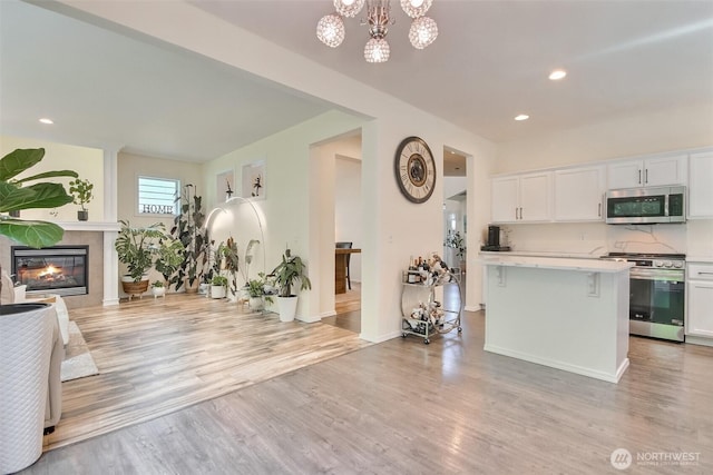 35055 41st Pl S, Auburn, WA 98001 - kitchen featuring stainless steel appliances, light countertops, light wood-style flooring, white cabinetry, and recessed lighting