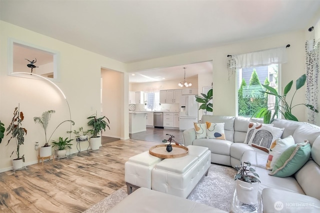 35055 41st Pl S, Auburn, WA 98001 - living room featuring a chandelier, light wood-style floors, and plenty of natural light