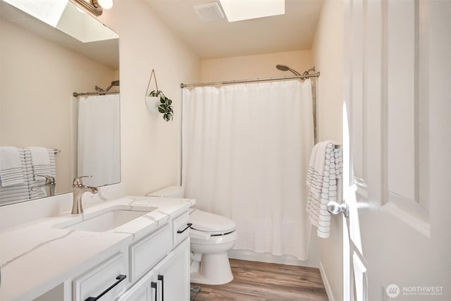 35055 41st Pl S, Auburn, WA 98001 - bathroom with vanity, wood finished floors, a skylight, and curtained shower