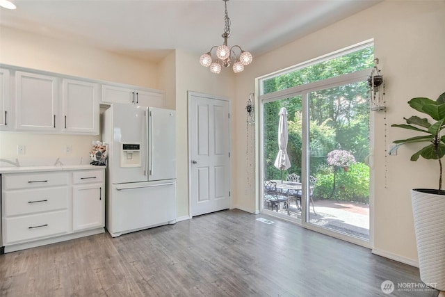 35055 41st Pl S, Auburn, WA 98001 - kitchen with white fridge with ice dispenser, a chandelier, white cabinets, and light countertops