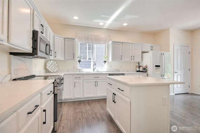 35055 41st Pl S, Auburn, WA 98001 - kitchen with stainless steel appliances, light wood-type flooring, recessed lighting, a kitchen island, and white cabinets